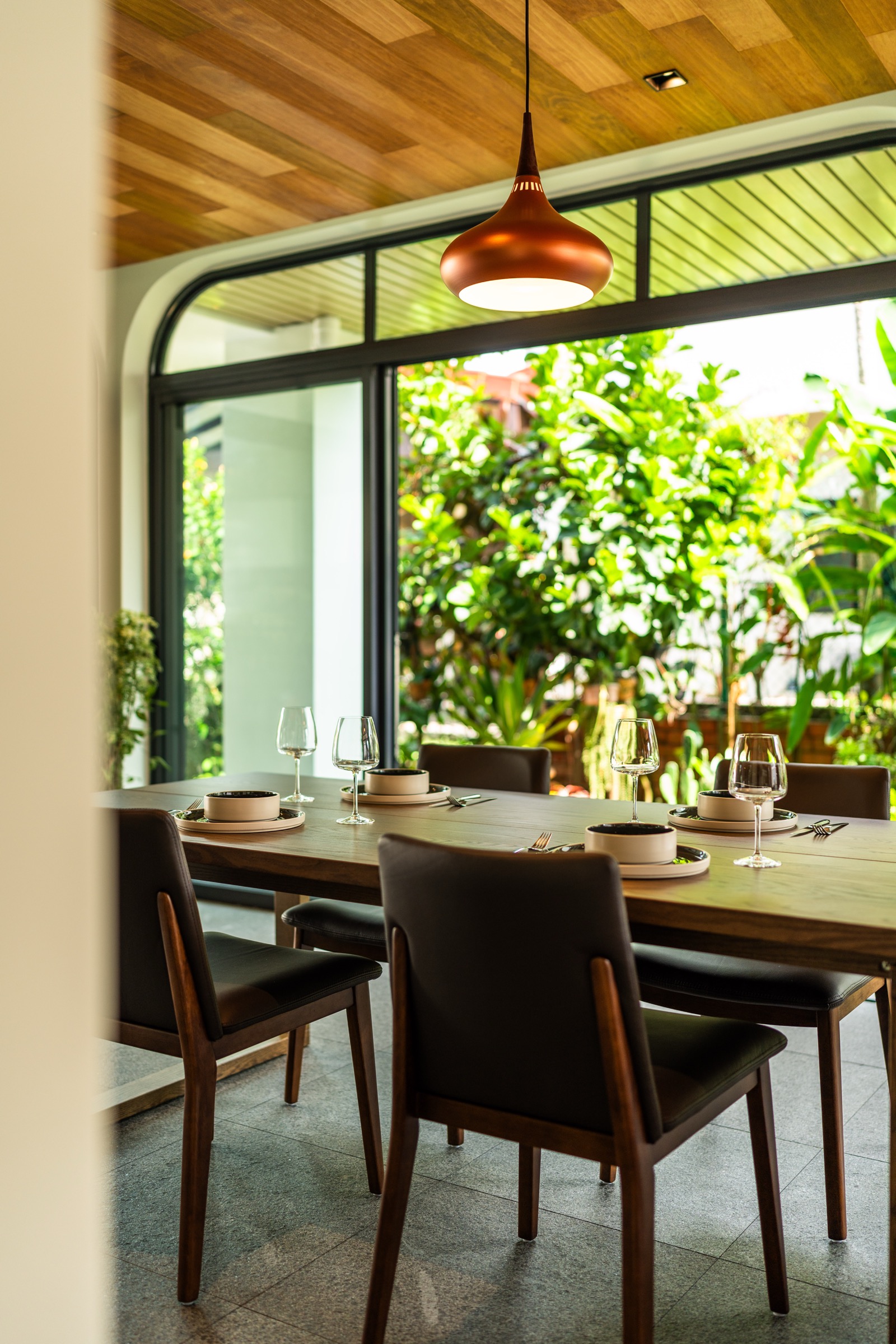 The dining pavilion at the edge of the lush garden