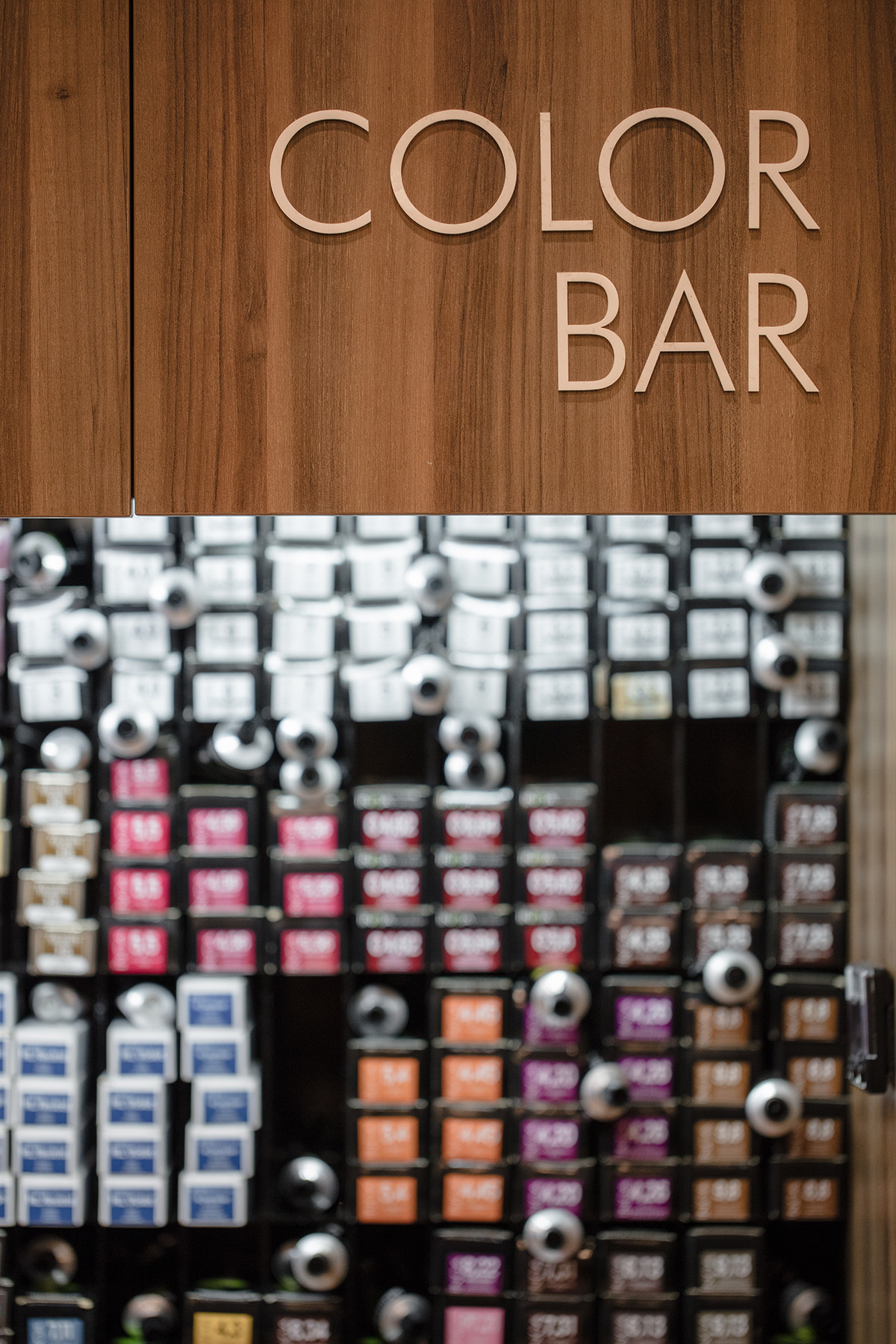 Detail of the timber and concrete tile material palette inside the salon