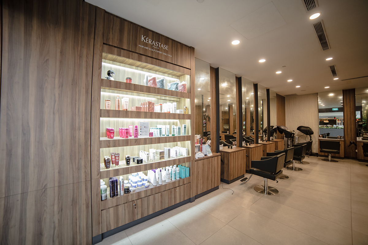 Wide view of the salon floor with styling chairs and timber joinery