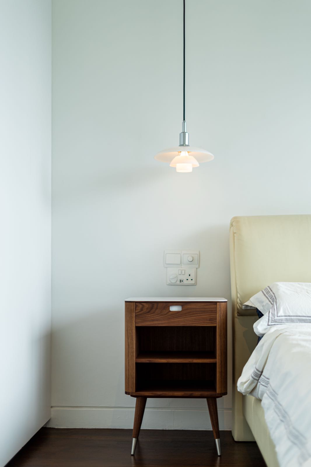 Master bedside still life with Louis Poulsen PH 3/2 pendant lamp and a walnut nightstand
