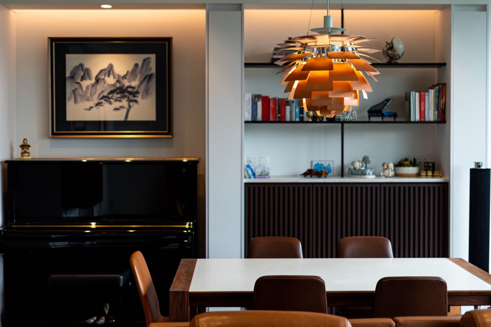 Dining area with Steinway upright piano and built-in bookshelf