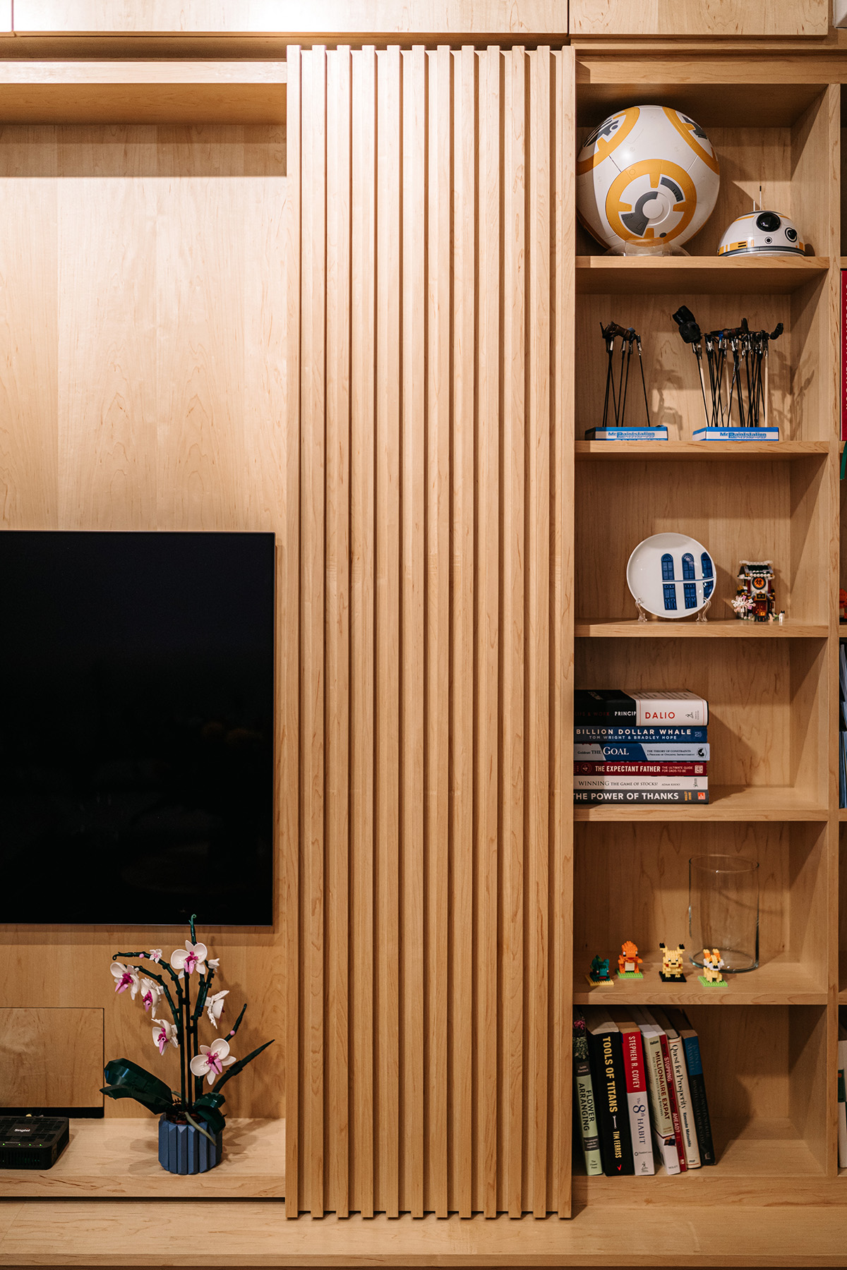 Detail of timber joinery and a quiet still life in the living space