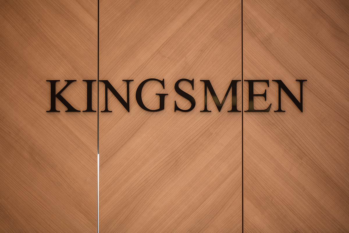 Wide view of the Kingsmen barber floor with chairs and the bar