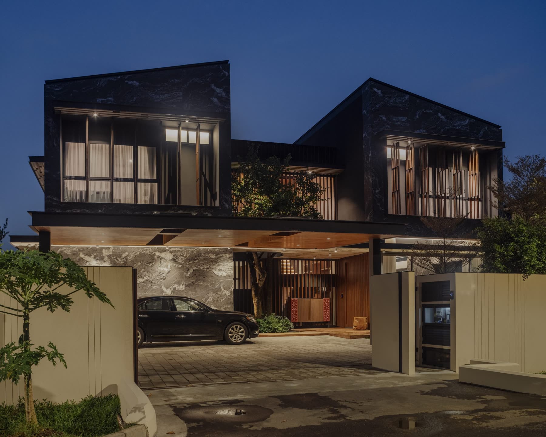 Quarry of Qi by Quod Architects at night, the marble facade lit from within