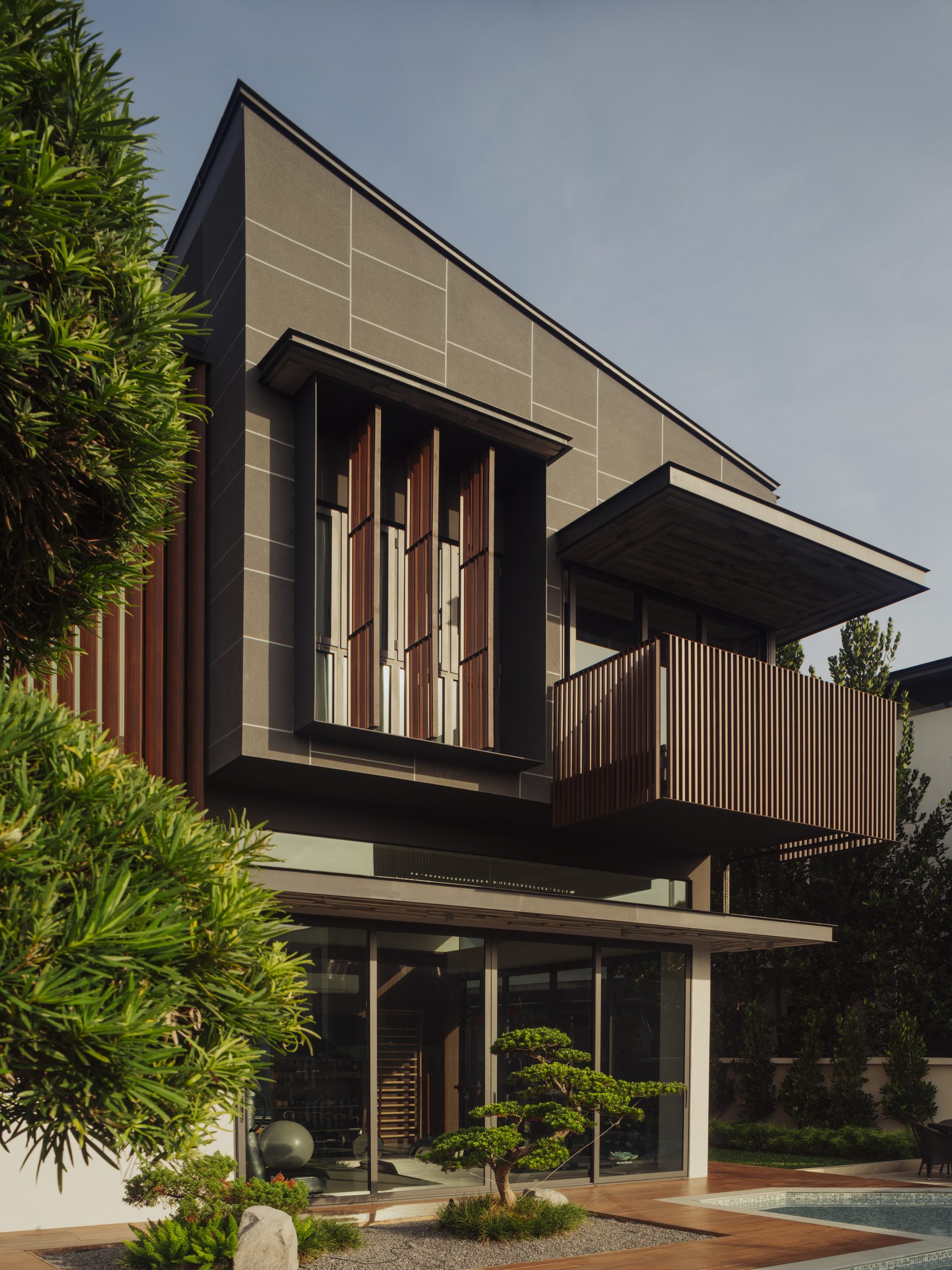 Side elevation with timber screens and a cantilevered upper storey above the garden
