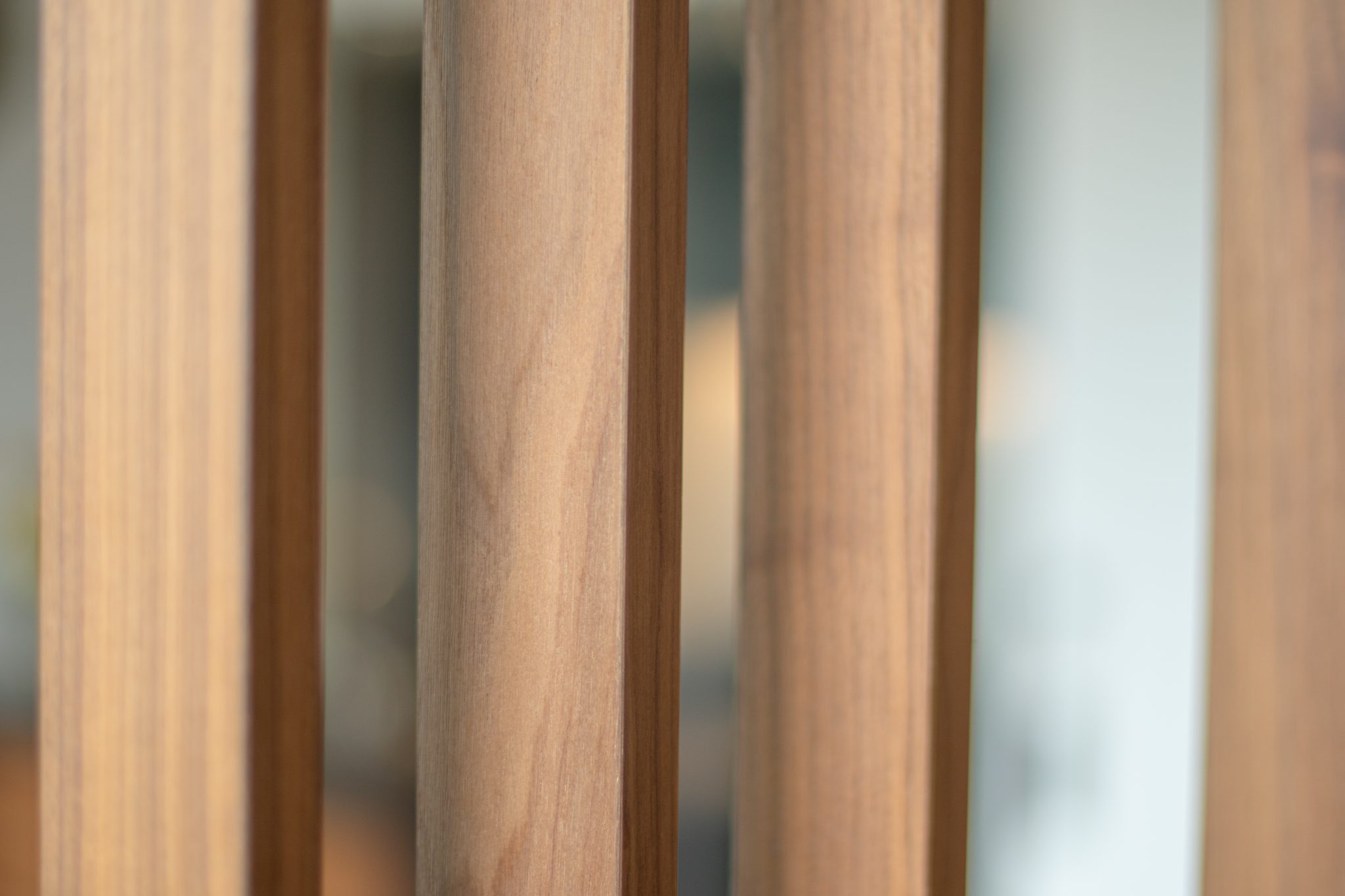 Close view of the walnut display shelving holding the family's books and collected objects