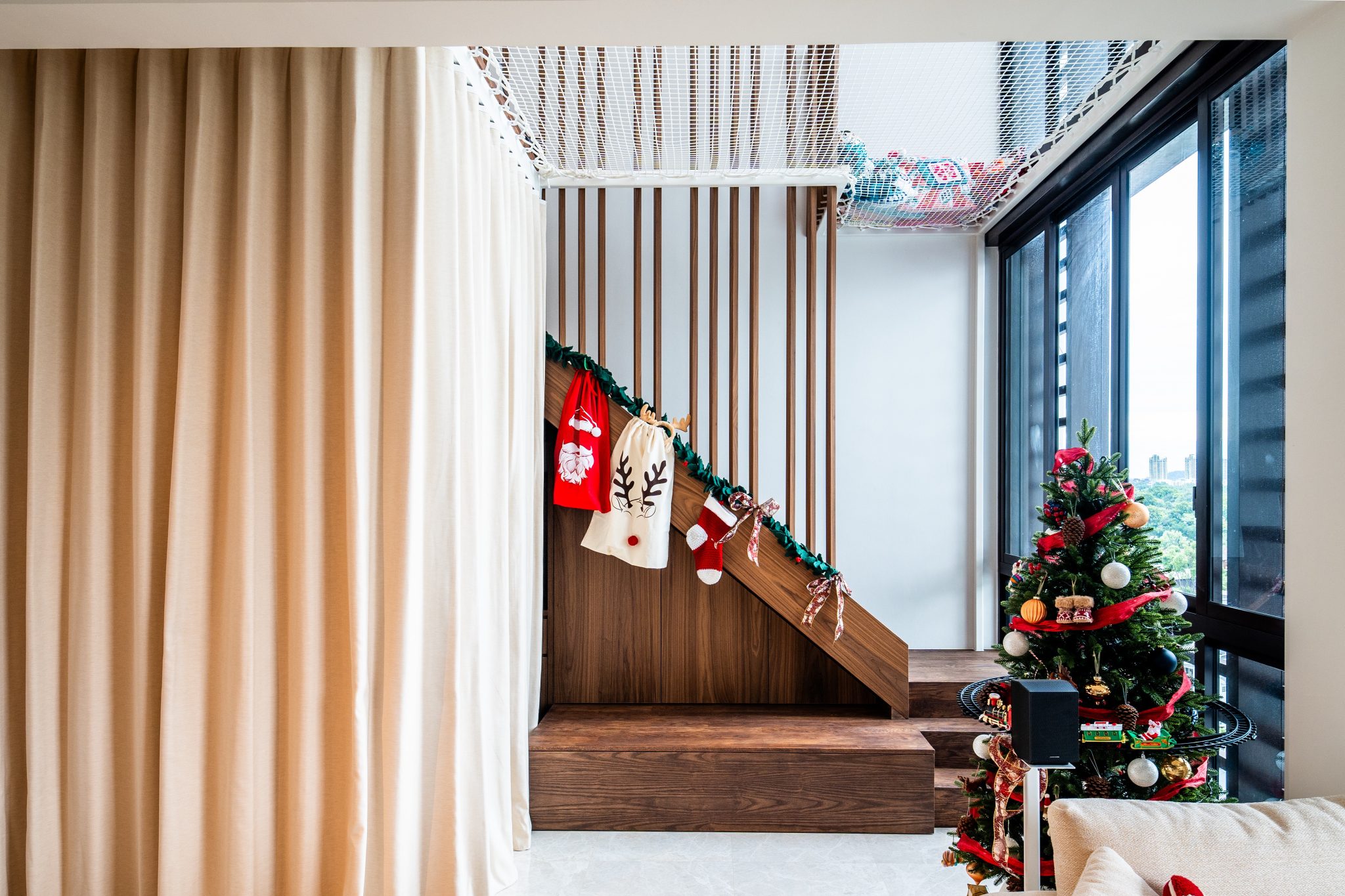 View toward the timber loft stair with a soft curtain wall drawn closed alongside it