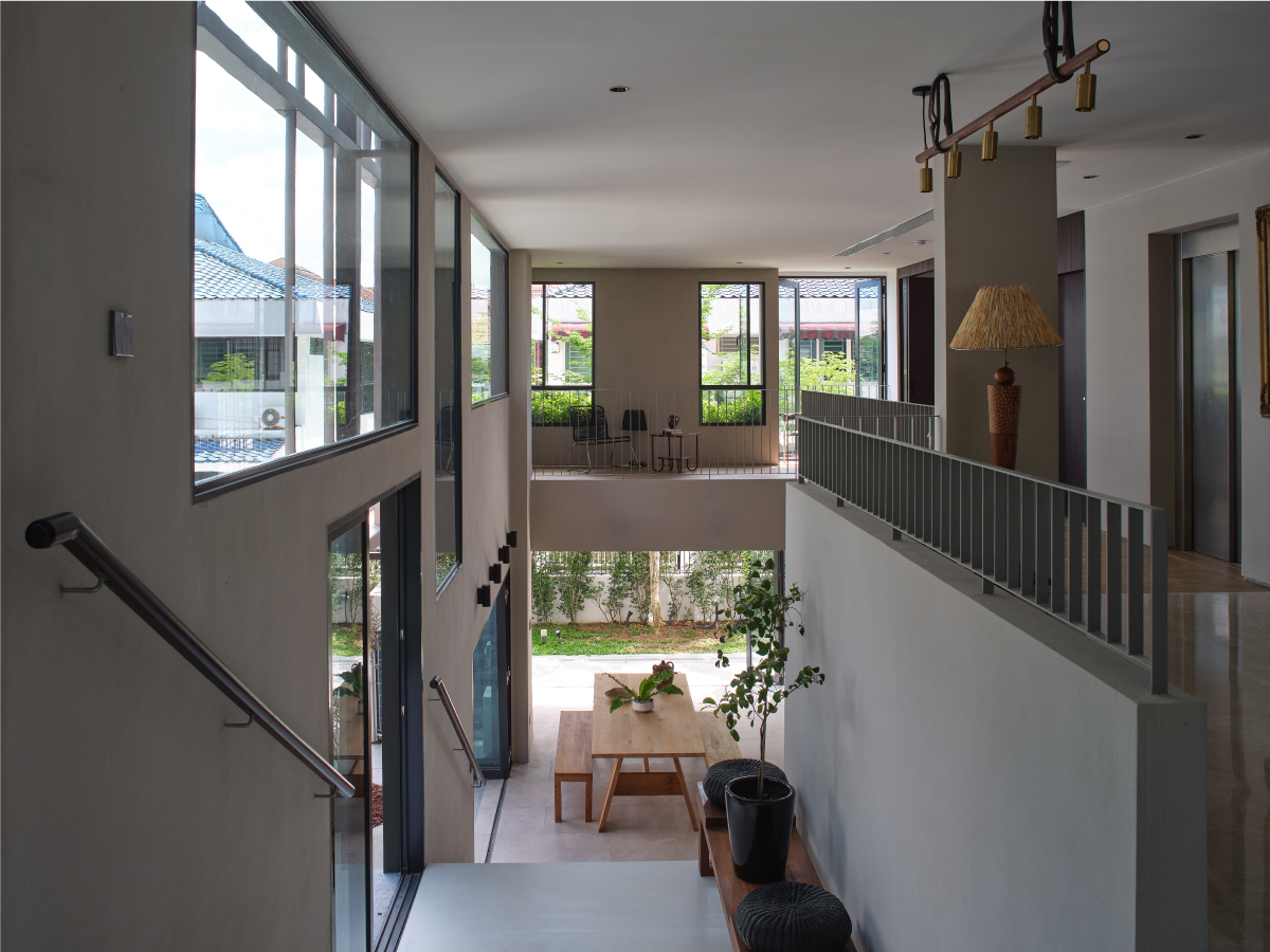 Glazed stair landing overlooking the central light well and the planted courtyard below