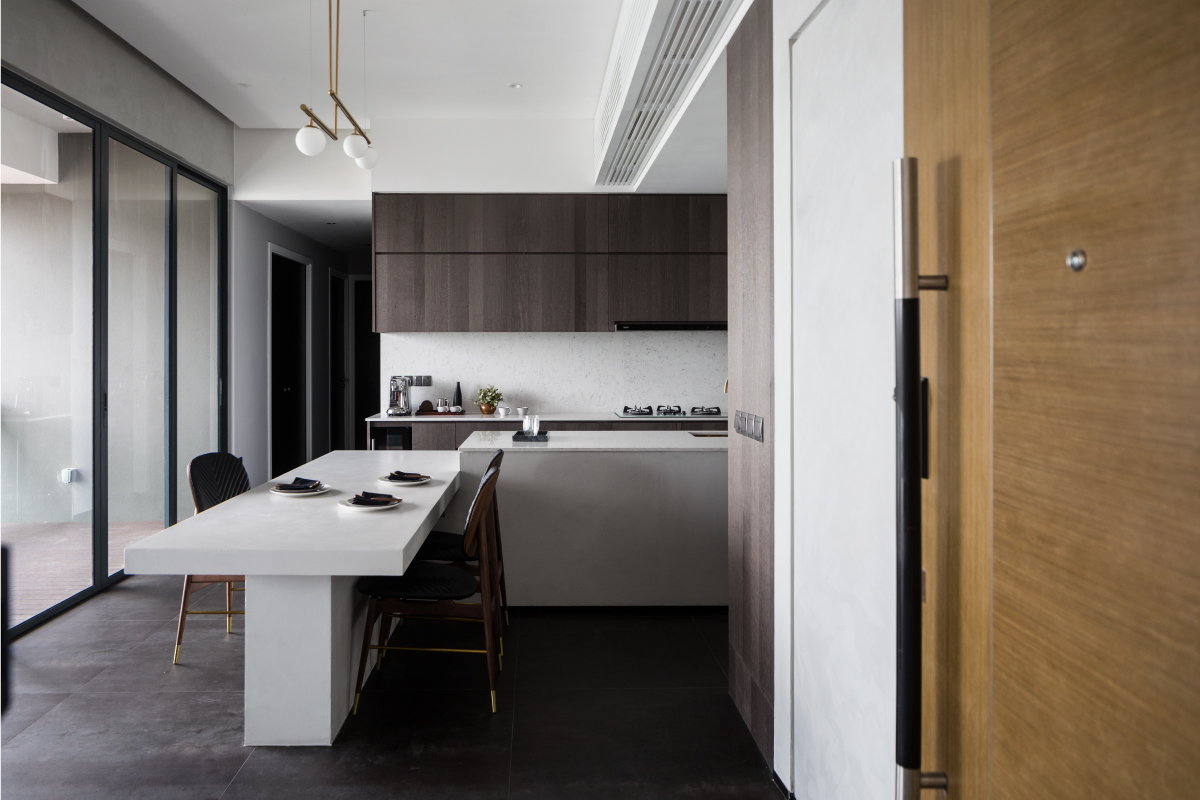 Open dining and kitchen area of The Trizon apartment with a sculptural concrete centrepiece